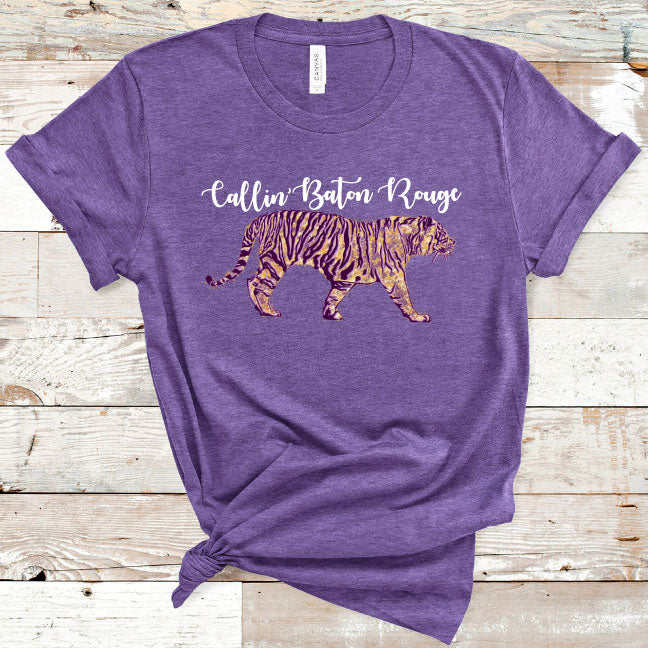 Heather Purple Tee. Graphic has a tiger in the LSU colors of purple and gold text above the tiger reads callin baton rouge in cursive 